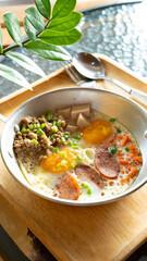 fried egg with sausage and pork meat topping