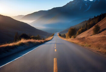 Asphalt road and mountains with foggy landscape at sunset stock photo - obrazy, fototapety, plakaty