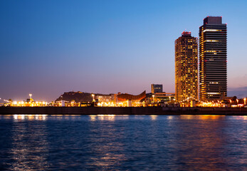 Urban landscape of Barcelona with view of Olympic Harbour and twin towers in evening time. - 758534698