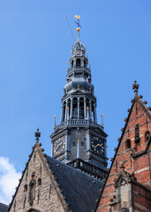 Fototapeta premium Oude Kerk (Old Church) in Amsterdam, Netherlands against blue sky.