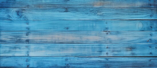 A stunning close up of a blue wooden wall with an electric blue hue. The intricate pattern showcases symmetry and parallel lines, creating a visually appealing design