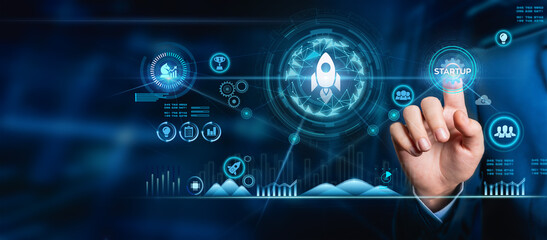 Startup concept. Businessman touches an icon of a transparent rocket that is launching and flying out with an icon network connection on a modern virtual interface.