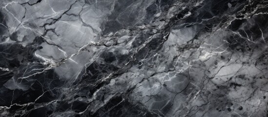 A detailed shot of a black and white marble texture resembling a natural landscape with elements of bedrock, soil, and darkness, captured in monochrome photography