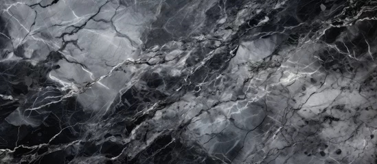 Deurstickers A detailed shot of a black and white marble texture resembling a natural landscape with elements of bedrock, soil, and darkness, captured in monochrome photography © 2rogan