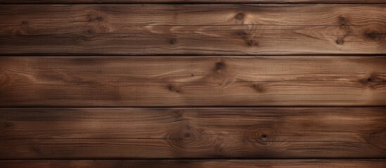 Fototapeta premium A detailed shot showcasing the rich brown hue of a hardwood plank flooring with a wood stain and varnish finish, creating a beautiful pattern on the wooden wall