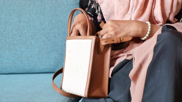 women looking for something in her purse