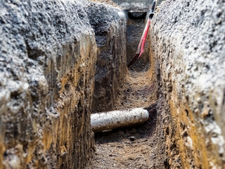 Plastic sewer pipe in trench at construction site