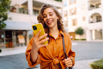 Beautiful woman with phone while walking in the street. Lifestyle, travel, tourism, technology,...