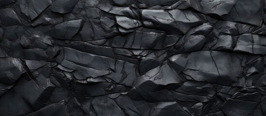 A detailed monochrome photography of a black rock texture, resembling a grey bedrock flooring with a unique pattern, set against a serene water landscape