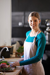 Smile, cooking and woman with ingredients in kitchen cutting vegetables with knife at home. Happy, groceries and portrait of female person with produce for dinner, supper or meal at apartment.