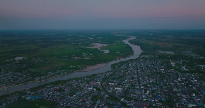 Arauca, colombia at dusk, showing the river and urban landscape, aerial view