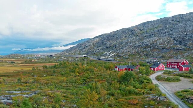Aerial: swedish train leaving Bj&oslash;rnfjell station in northern Norway and close Riksgr&auml;nsen, in the Swedish border