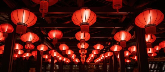 Red and white lanterns are suspended overhead. - obrazy, fototapety, plakaty