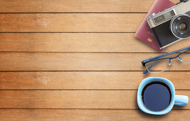 Coffee cup,camera and glasses on wooden table