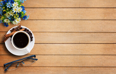 Coffee cup and glasses on wooden table