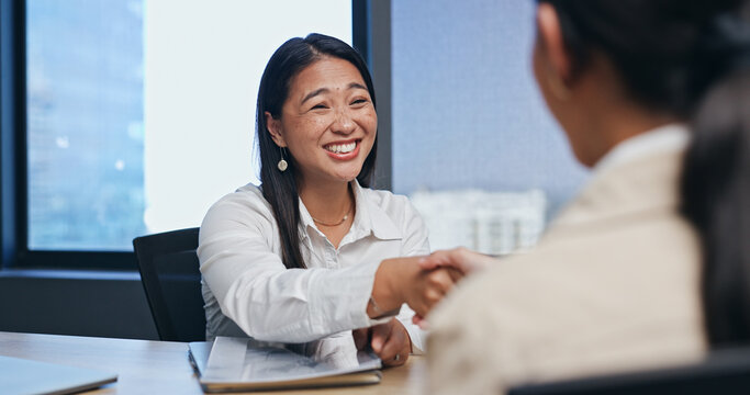 Business, woman and handshake in job interview for introduction in meeting with smile or excited in office. Asian candidate, hr employee or shaking hands with documents for hiring deal or recruitment