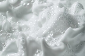 Image is of white foam with bubbles and water droplets - obrazy, fototapety, plakaty