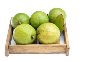 Organic Harvested Guava Fruit in a Wooden Tray Isolated on White Background with Copy Space