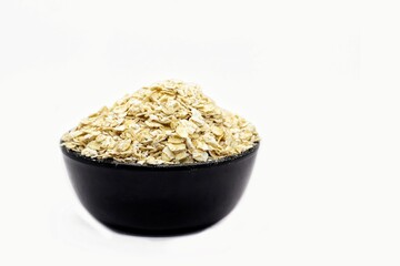 Oat in a Black Bowl Isolated on White Background with Copy Space