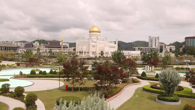 panning shot of the tropical gardens and beauitful landscaping in front of Sultan Omar Ali Saifuddien Mosque in Bandar Seri Bagawan in Brunei Darussalam

