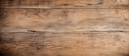 A closeup of a brown hardwood rectangular table with a grainy texture, featuring a beautiful wood stain. The landscape pattern on the plywood flooring enhances the natural beauty of the wood