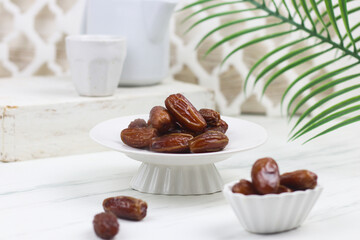 Kurma or Dates fruit on marble white background. Breakfasting concept in Ramadan month. Islamic template for text background.
