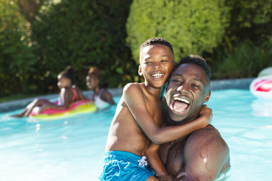 A joyful African American family enjoys a pool day at home - Powered by Adobe