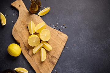 Sliced lemon fruit on a wooden cutting board at domestic kitchen