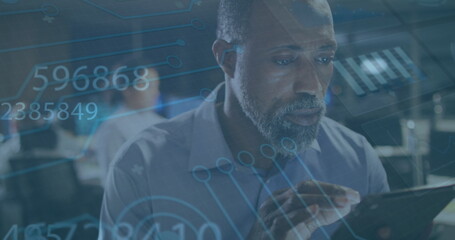 Image of data processing over african american businessman using tablet