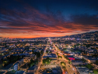 Aerial panorama of city of West Hollywood art dusk. Los Angeles, California. A vibrant sunset blankets the sky with shades of pink and orange, casting a warm glow over a bustling cityscape panorama. - 758622447
