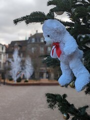 Christmas Market in Colmar, France, November 2023, teddy bear on a Christmas tree.