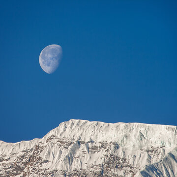Moon over the snow-capped mountains of Tibet