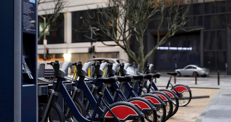 Generic Electric bicycle charging station. Shared electric bikes parked for rent on city street