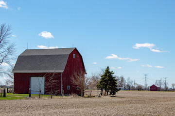 A large red barn in the countryside.