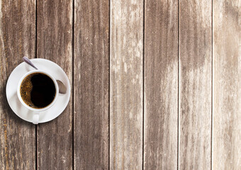 Cup of coffee on wooden table background