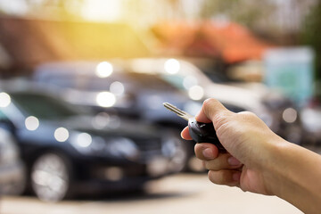 Female hand holding a car key