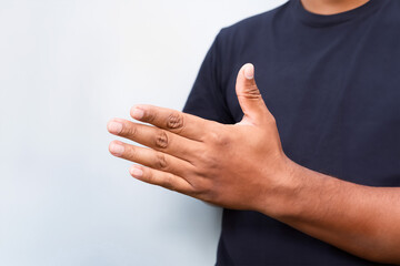 Closeup of man hand showing stop gesture on blue background. Copy space