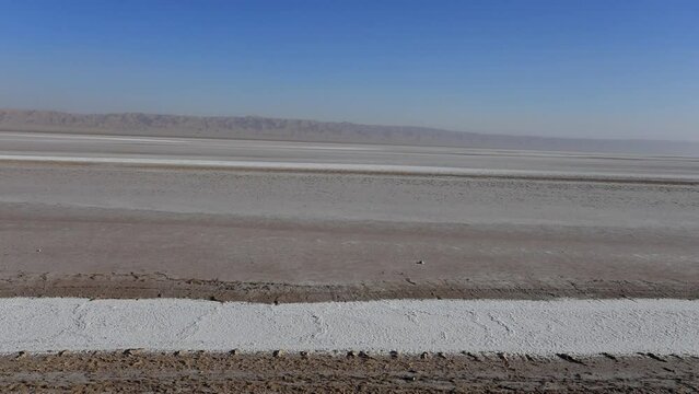 Vast Tunisian salt desert under clear blue sky, Chott el Jerid