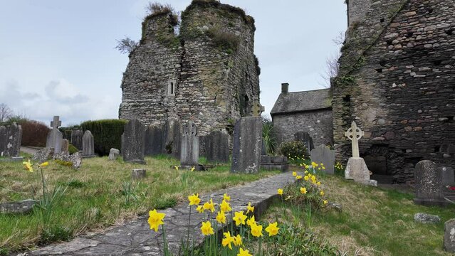 Ancient Cemetery on a spring morning with castle and old headstones