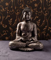 Meditating Buddha Statue on dark background. Soft focus. Close up. Copy space.	