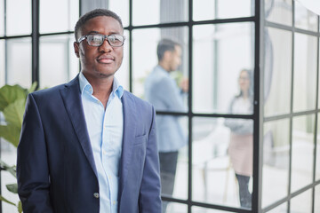 Handsome young man in design office posing at camera