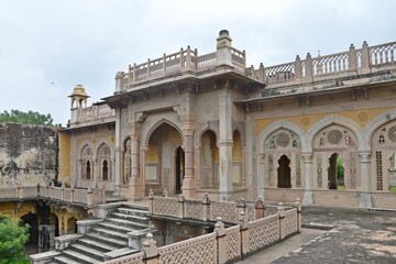 Obraz premium Majestic Royal Cenotaphs Amidst Verdant Greenery Under Cloudy Skies at Maharani Ki Chhatri ,Jaipur, Rajasthan, India