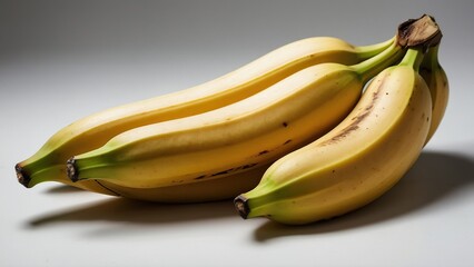 Several bananas on a light background.