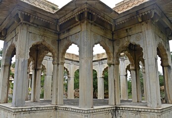 Obraz premium Majestic Royal Cenotaphs Amidst Verdant Greenery Under Cloudy Skies at Maharani Ki Chhatri ,Jaipur, Rajasthan, India