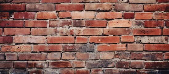 A detailed close up of a red brick wall showcasing the intricate pattern of rectangular bricks. The brickwork forms a strong and durable facade, making it a popular building material choice