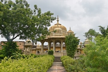 Majestic Royal Cenotaphs Amidst Verdant Greenery Under Cloudy Skies at Maharani Ki Chhatri ,Jaipur,...