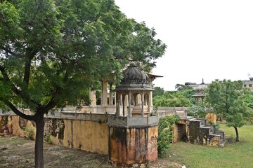 Majestic Royal Cenotaphs Amidst Verdant Greenery Under Cloudy Skies at Maharani Ki Chhatri ,Jaipur, Rajasthan, India