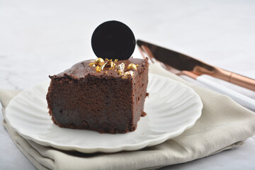 premium freshly baked dark cocoa chocolate brownie gold flower and earl grey peanut round birthday cake with walnut in wood bento box on white marble halal food sweet dessert menu for pastry cafe shop