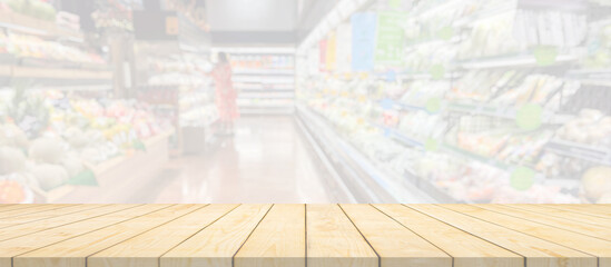 Wood table top with supermarket grocery store blurred background with bokeh light for product display