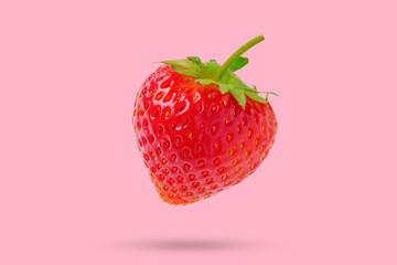 Strawberry floated on pink background close up